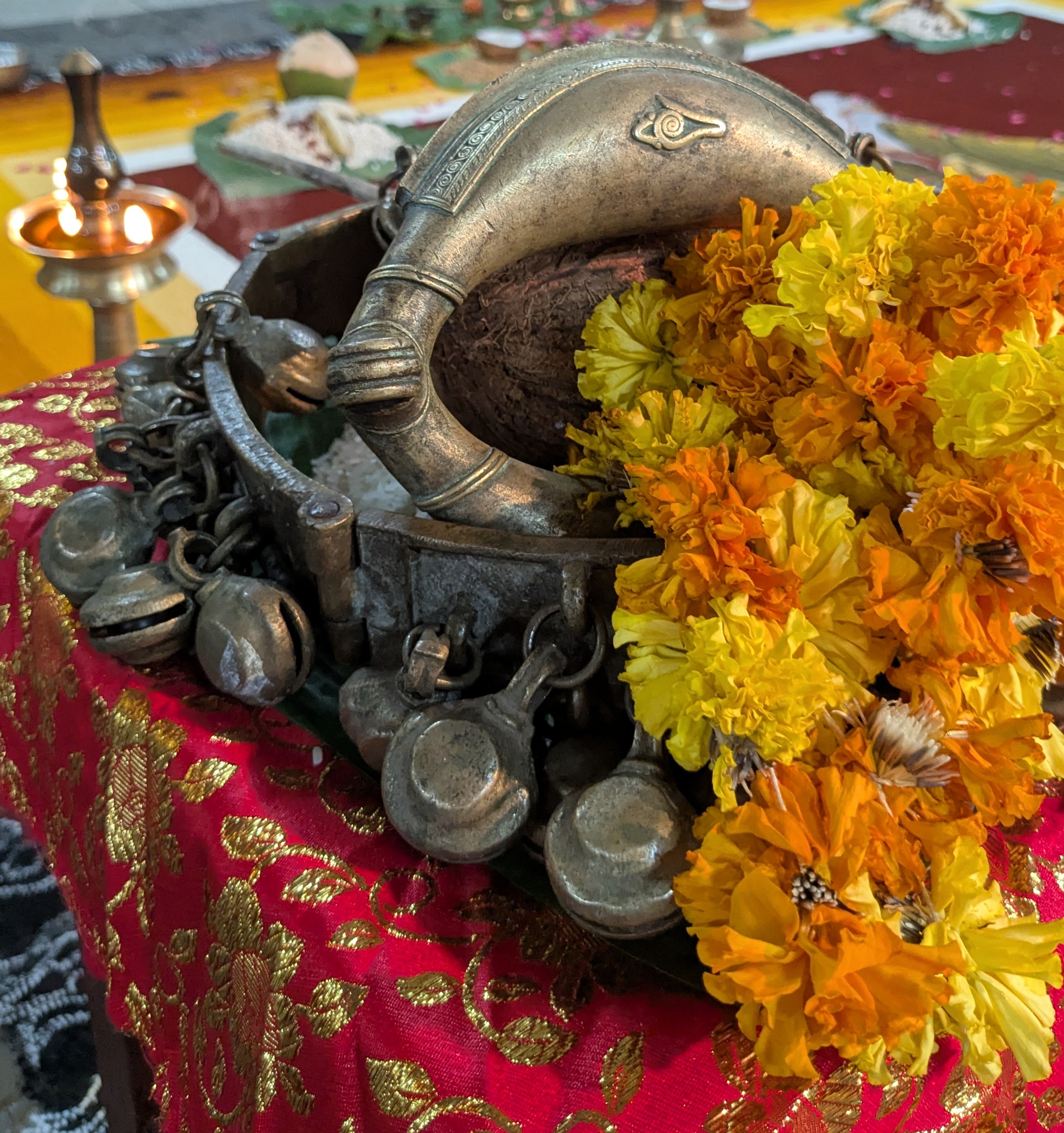 Sacred anklets adorned with marigold garlands - traditional temple artifacts